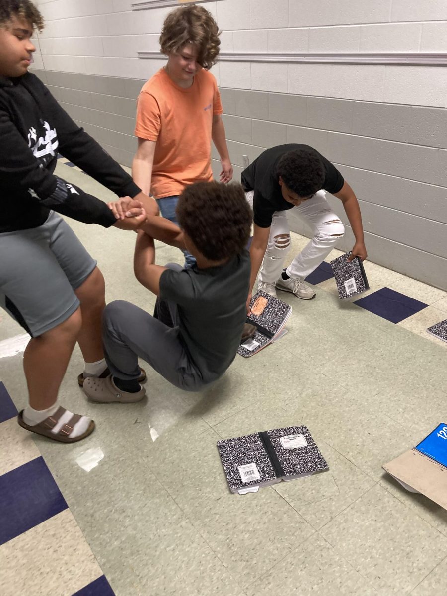 A group of students helping a boy who has been bullied 