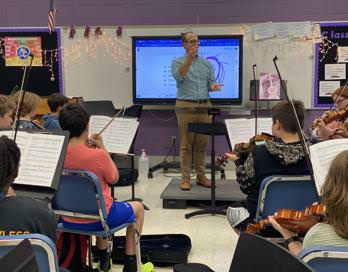 Mr.Case is Conducting his class at BGJHS during the school day, teaching them to be better for the upcoming concert