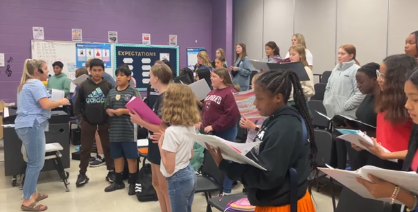 The choir students practice their songs for the concert coming up on October 24. 