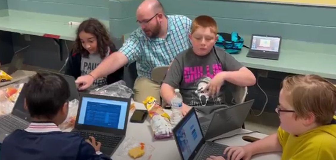 Mr.Staggs helps his students at Tabletop club, solving problems with them.