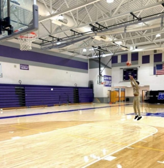 8th grader Anthony Davis practicing basketball in the gym