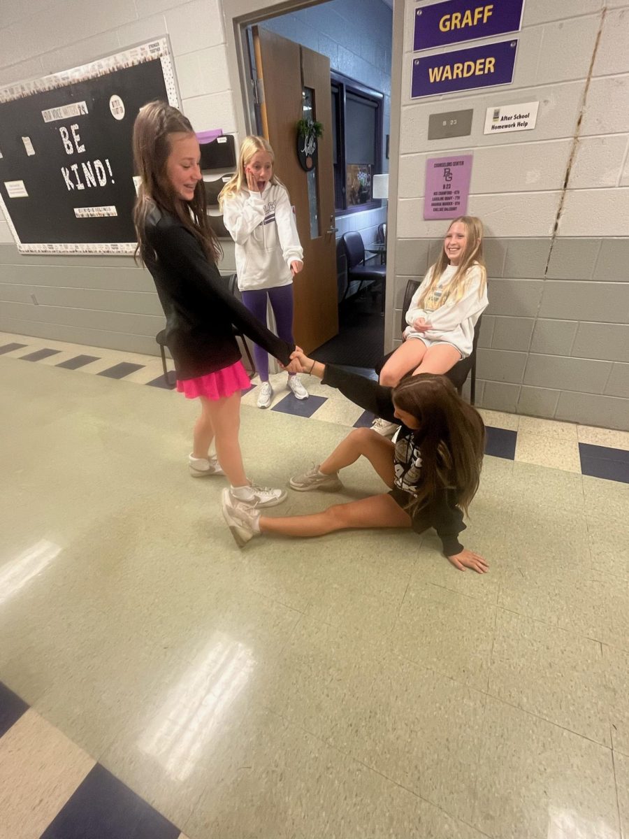 7th grader at BGJHS, Maddie Fisher helps a friend after falling over.