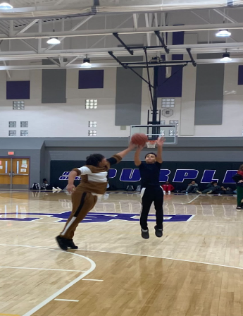 8th grader Peyton gets his shot absolutely blocked by 8th grader Jaquavion while playing basketball during PE, benefiting their physical health,having fun before Thanksgiving break.