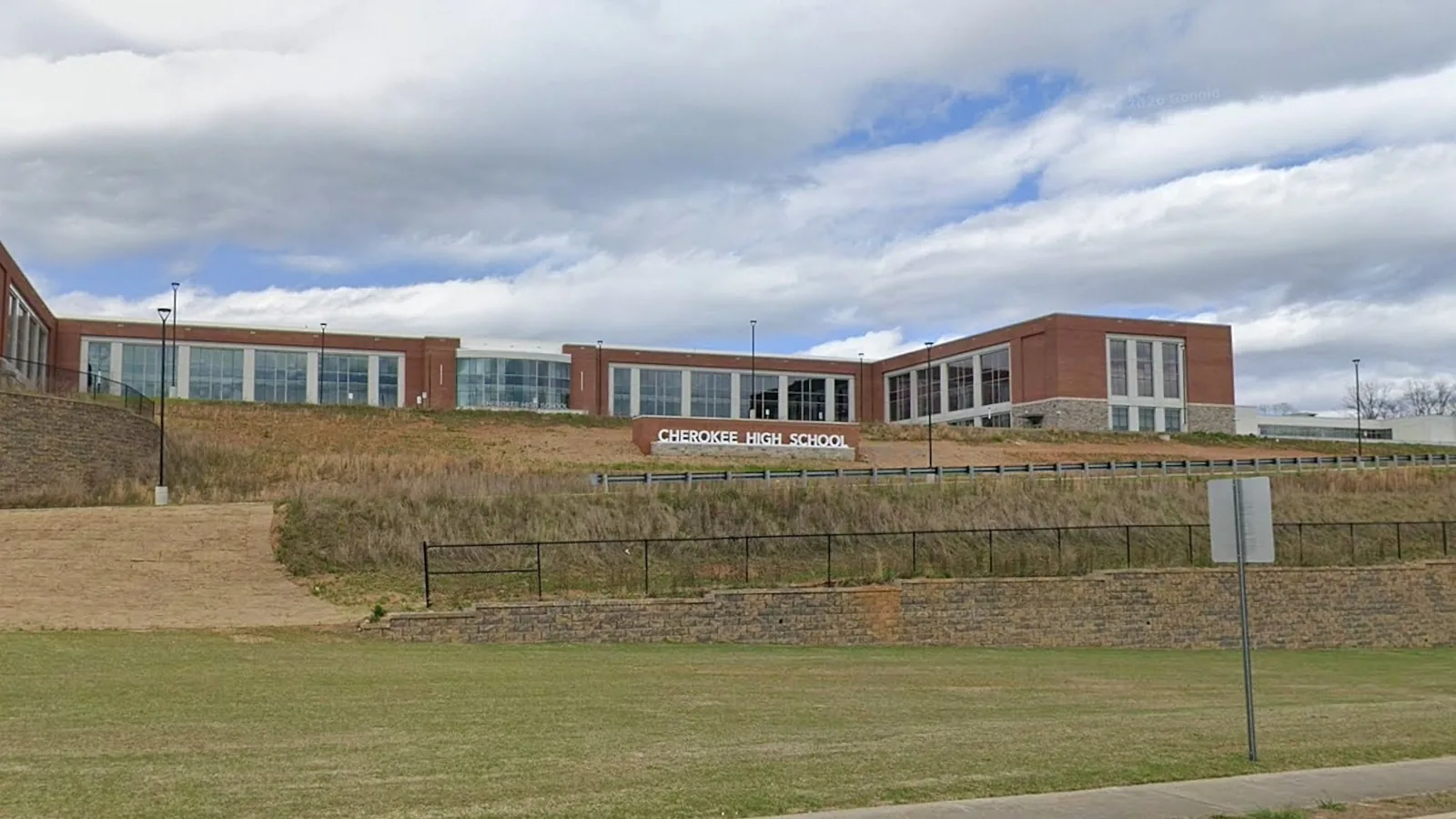 Police lights outside a Georgia school district building after arrests in a threatened school shooting plot