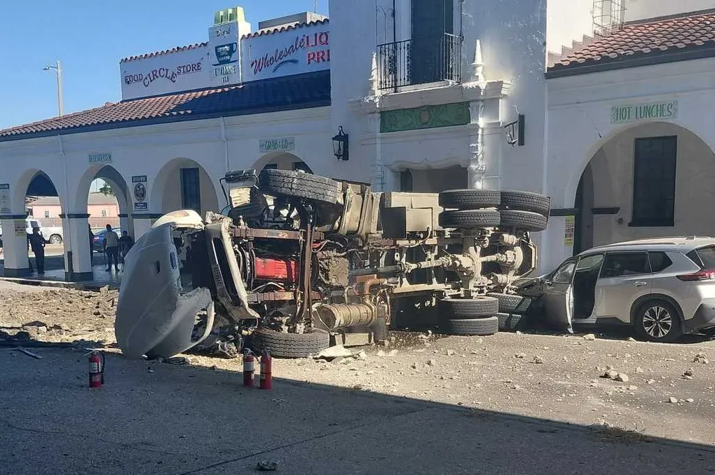 Dump truck crashed off an Interstate 10 bridge in New Orleans with debris on the street below