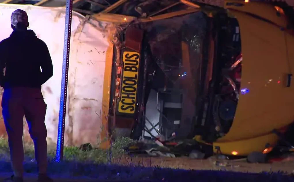 Overturned school bus at a Rockdale County intersection with emergency crews nearby