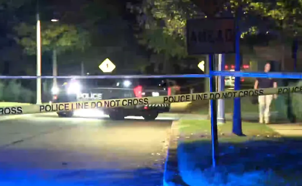 Police tape and emergency vehicles near a shooting scene in Woodstock, Georgia